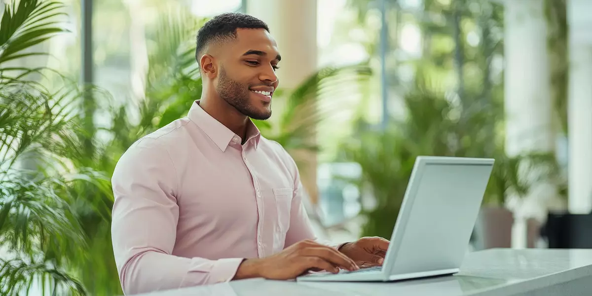 A-person-smiling-while-using-their-computer-or-phone