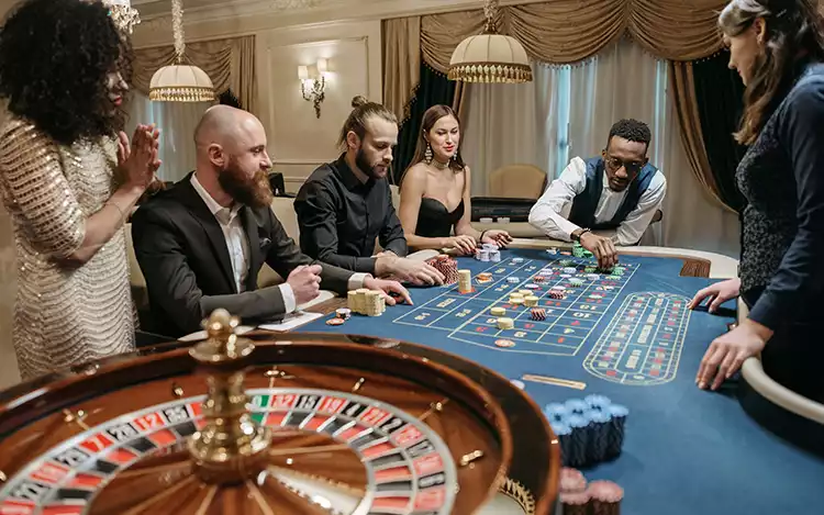 two people playing card games on roulette table