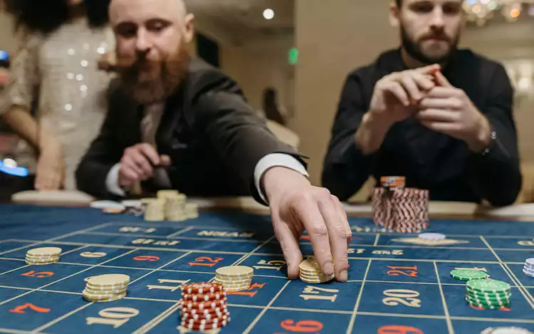 Hands playing at a roulette table