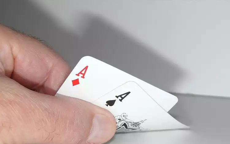 blackjack player holding playing cards
