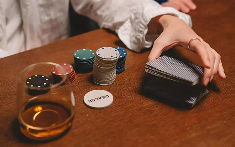 a table with cards and glass of wine