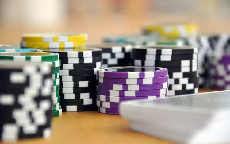 purple, black, and green casino chips