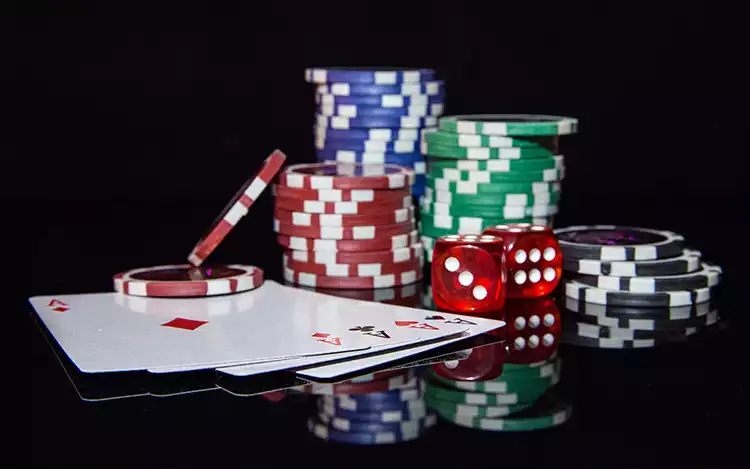 casino chips, dice and cards on a table