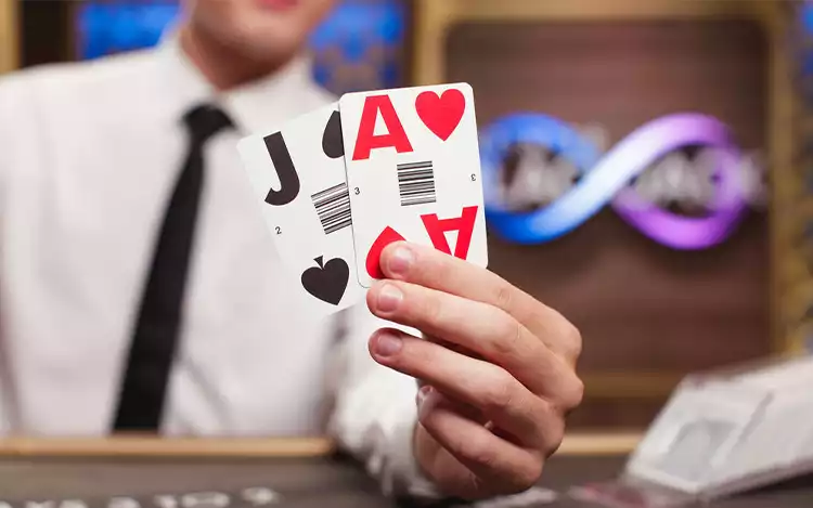 dealer holding cards in live blackjack game