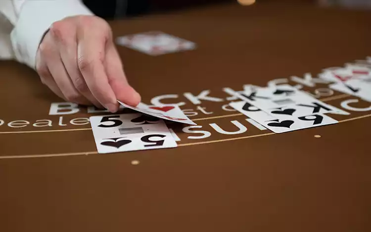 dealer laying cards on table