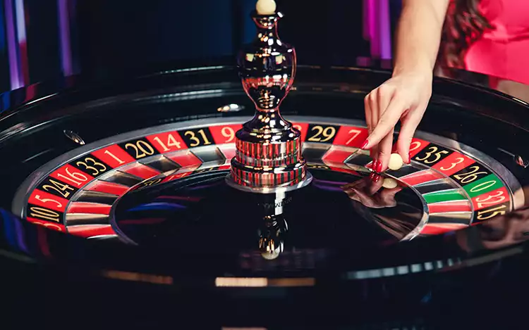 european roulette wheel with female croupier
