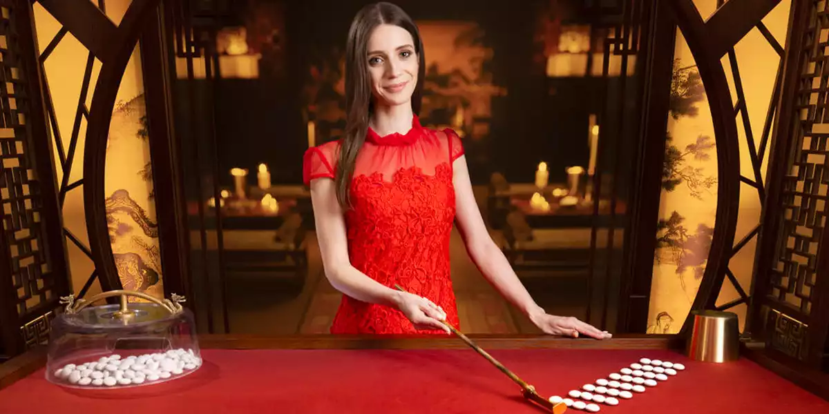 fan tan live dealer, table, and beads