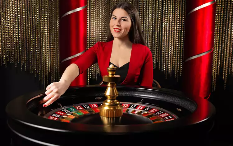 female live roulette dealer in red
