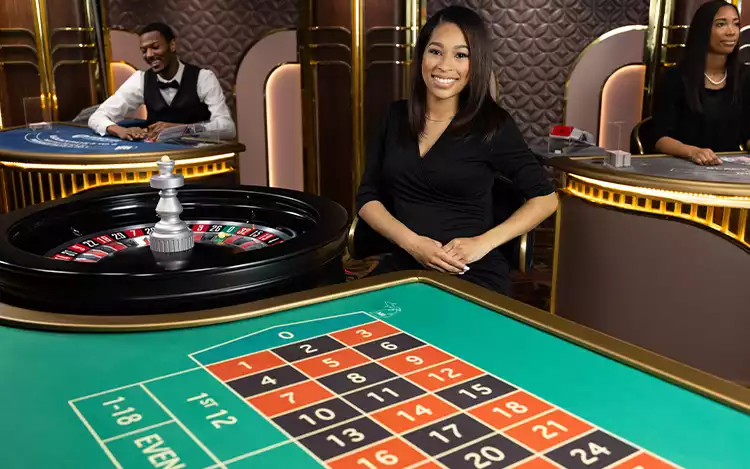 female live roulette dealer with other dealers