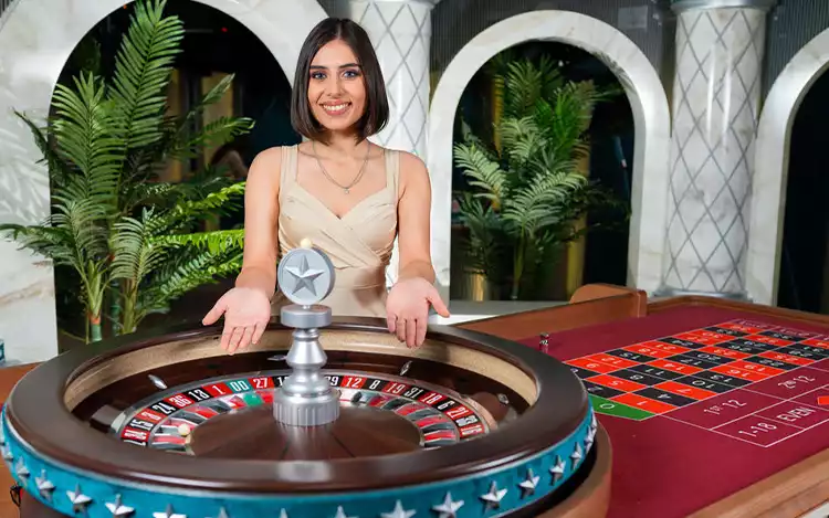 female live roulette dealer ready to spin the wheel