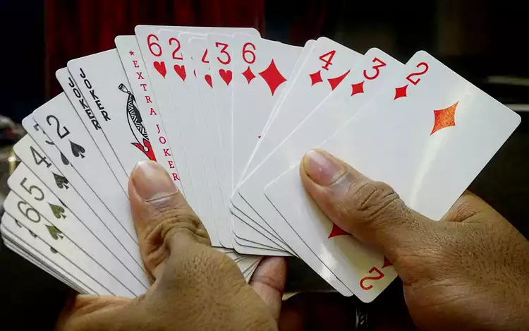 holding a deck of cards