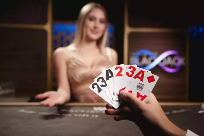 a man checking his cards in front of a dealer