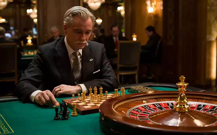 man playing chess on a roulette table