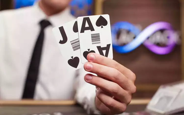 holding a jack and ace of spades cards