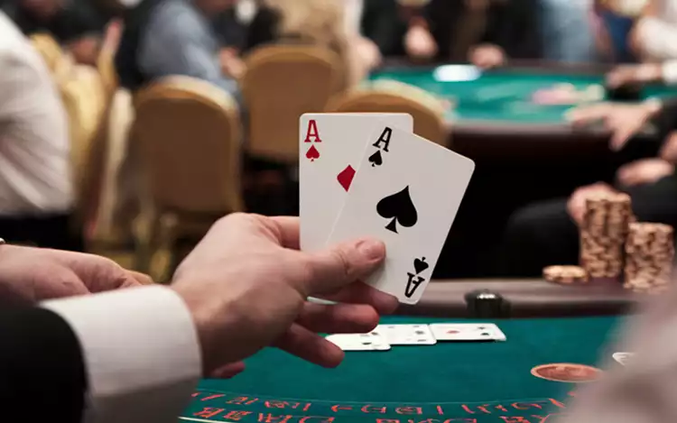 player holding two ace cards