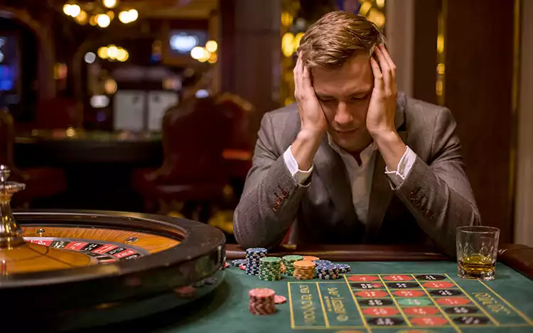 player looking dejected after losing a spin of the roulette wheel