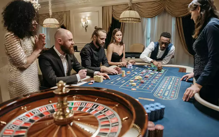 cards and dice are placed on the gambling table, as players look forward to the start of the game.