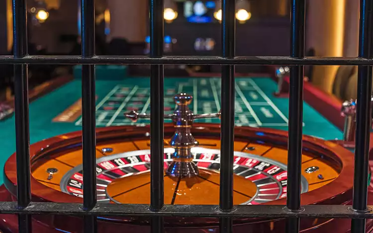 roulette wheel behind prison bars