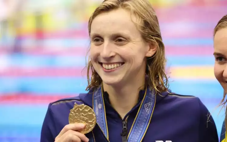 Katie Ledecky at the World Aquatics Championships in Fukuoka in 2023 holding up a gold medal after winning the Women's 800m Freestyle