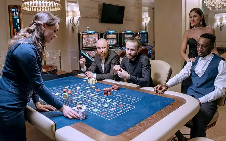 Croupier acknowledging a spoken bet and placing chips on the French roulette layout