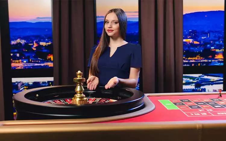 Live French roulette dealer in studio following table etiquette and announcing bets.