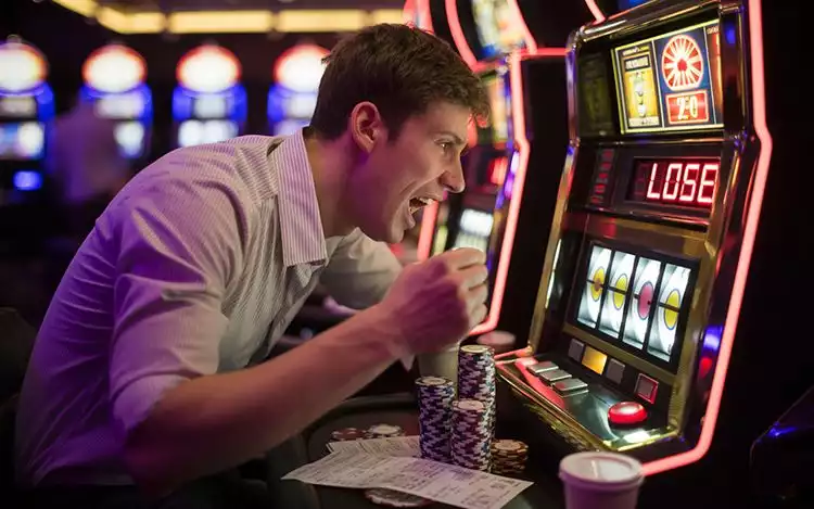 man enjoying slot machine play