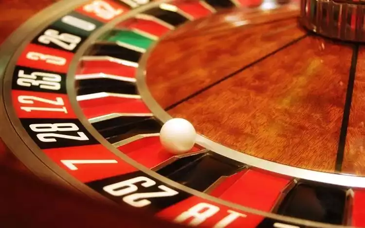 a ball in number seven red pocket of a roulette wheel.