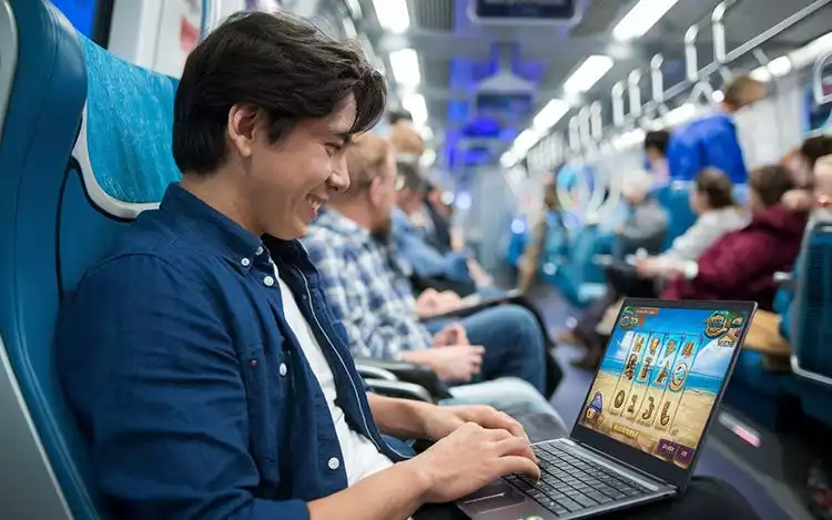 an online casino player enjoying low volatility slots while on commute