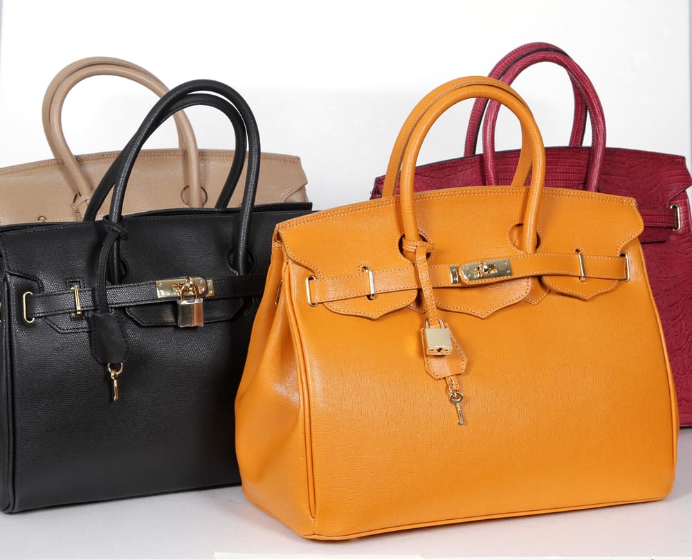 A selection of four Birkin bags, with two in front and two behind.