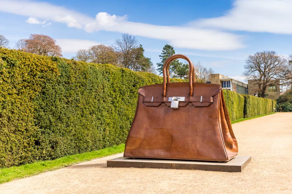 Outdoor display of Kalliopi Lemos’ sculpture of a Birkin, called Bag of Aspirations, in the scenic surroundings of Yorkshire Sculpture Park