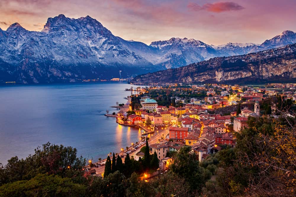 Panorama of Torbole in the winter time at sunset, surrounded by mountains