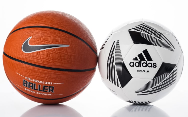 On the left is an orange Nike basketball with the word BALLER in the centre. On the right is a white and black Adidas football with varying diamond patterns