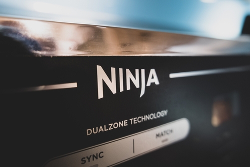 Close-up of Ninja DUALZONE TECHNOLOGY air fryer surface.