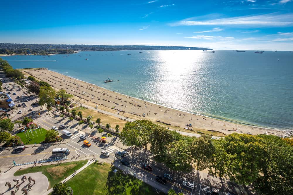 View of English Bay Beach with sea view in the upper right and the road in the lower left