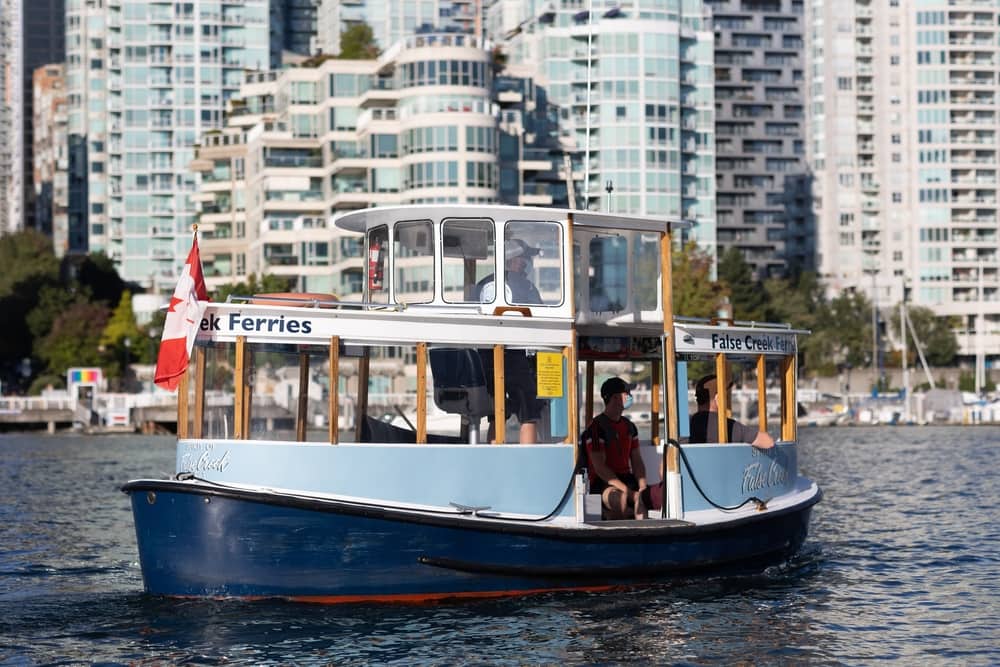 People on a boat tour with city view in the background