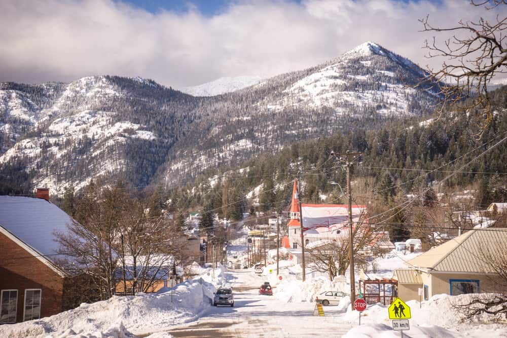 Village of Rossland with mountain in the background and church in the foreground with snow hilly streets