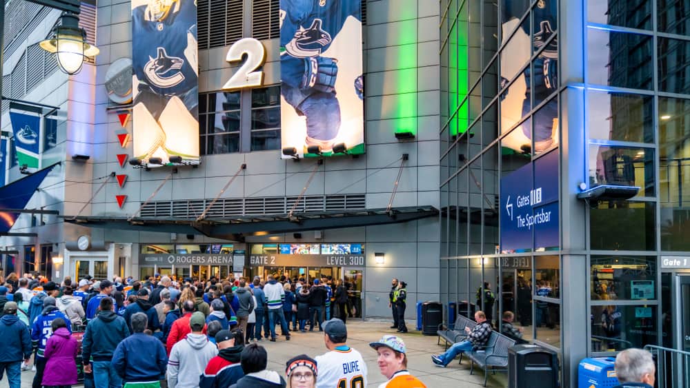 A crowd of people walking into Rogers Arena