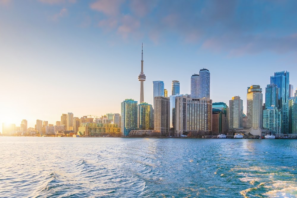 Downtown Toronto city skyline at sunset with water in front