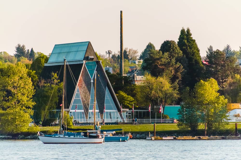 Waterfront view of the Vancouver Maritime Museum surrounded by trees with boats in the forefront
